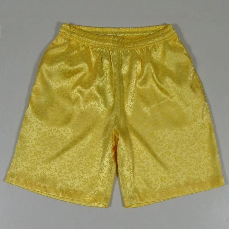 Men's black Tang suit shorts with a drawstring elastic waistband laid flat.