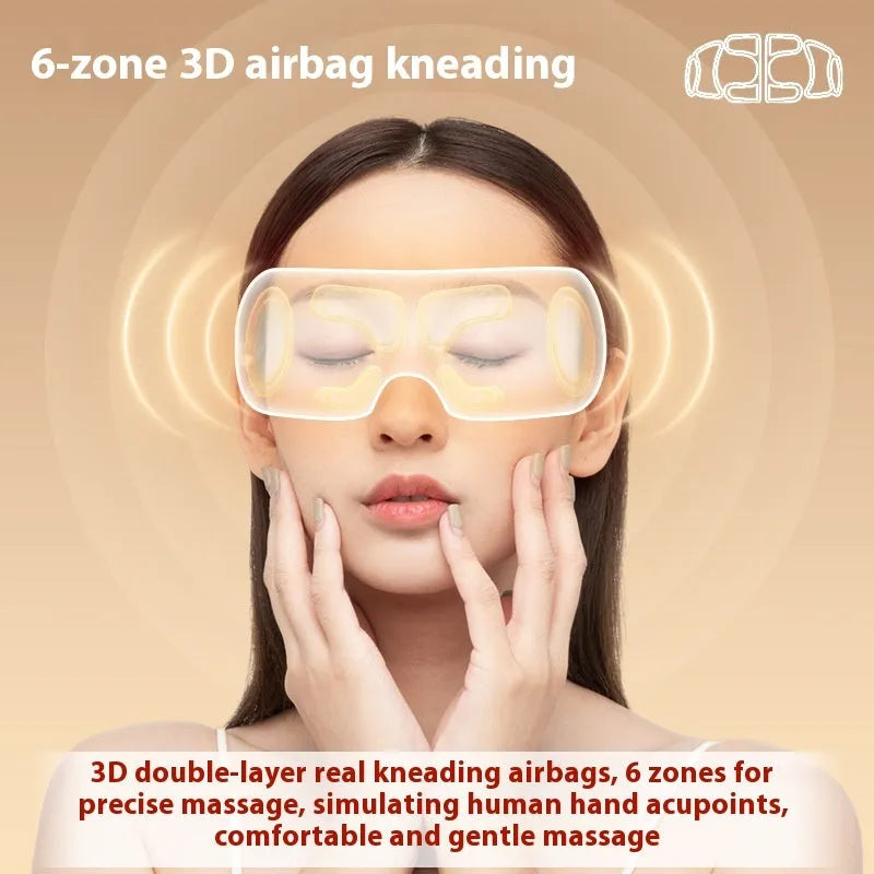 White rechargeable airbag eye massager with heat compress function on a grey background.