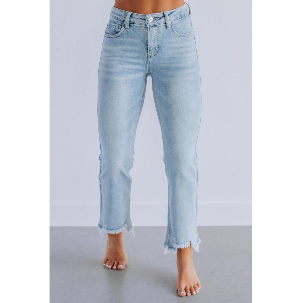 Women's solid dark blue denim casual pants with a hand-worn finish on a hanger.