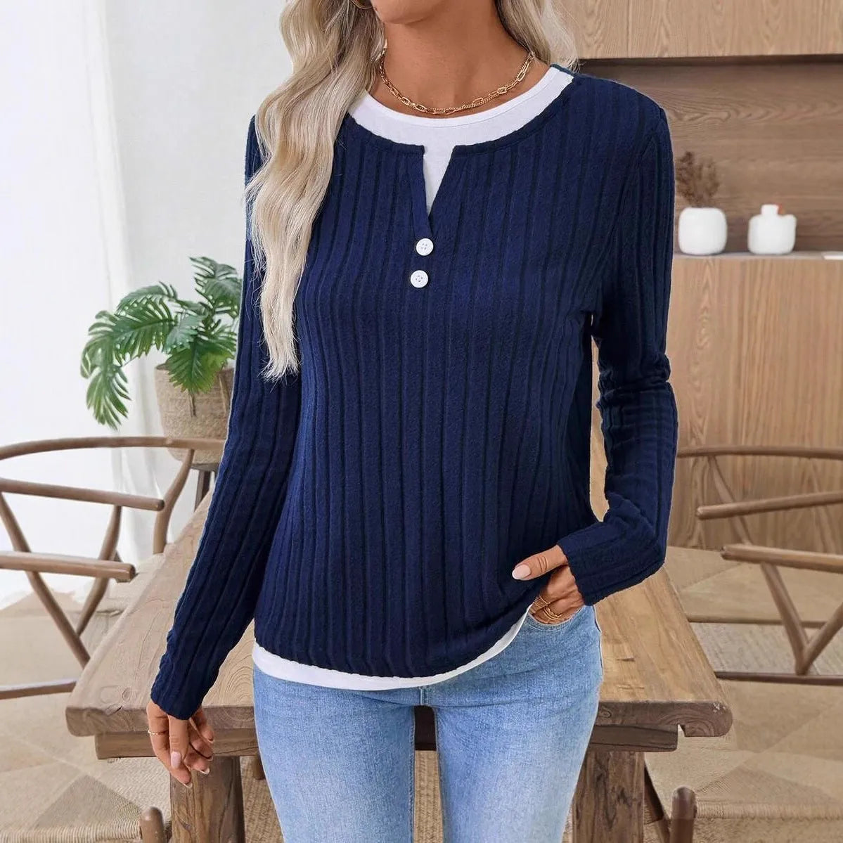 Women's black fake two-piece round neck pullover sweater with concave stripe texture and button details.