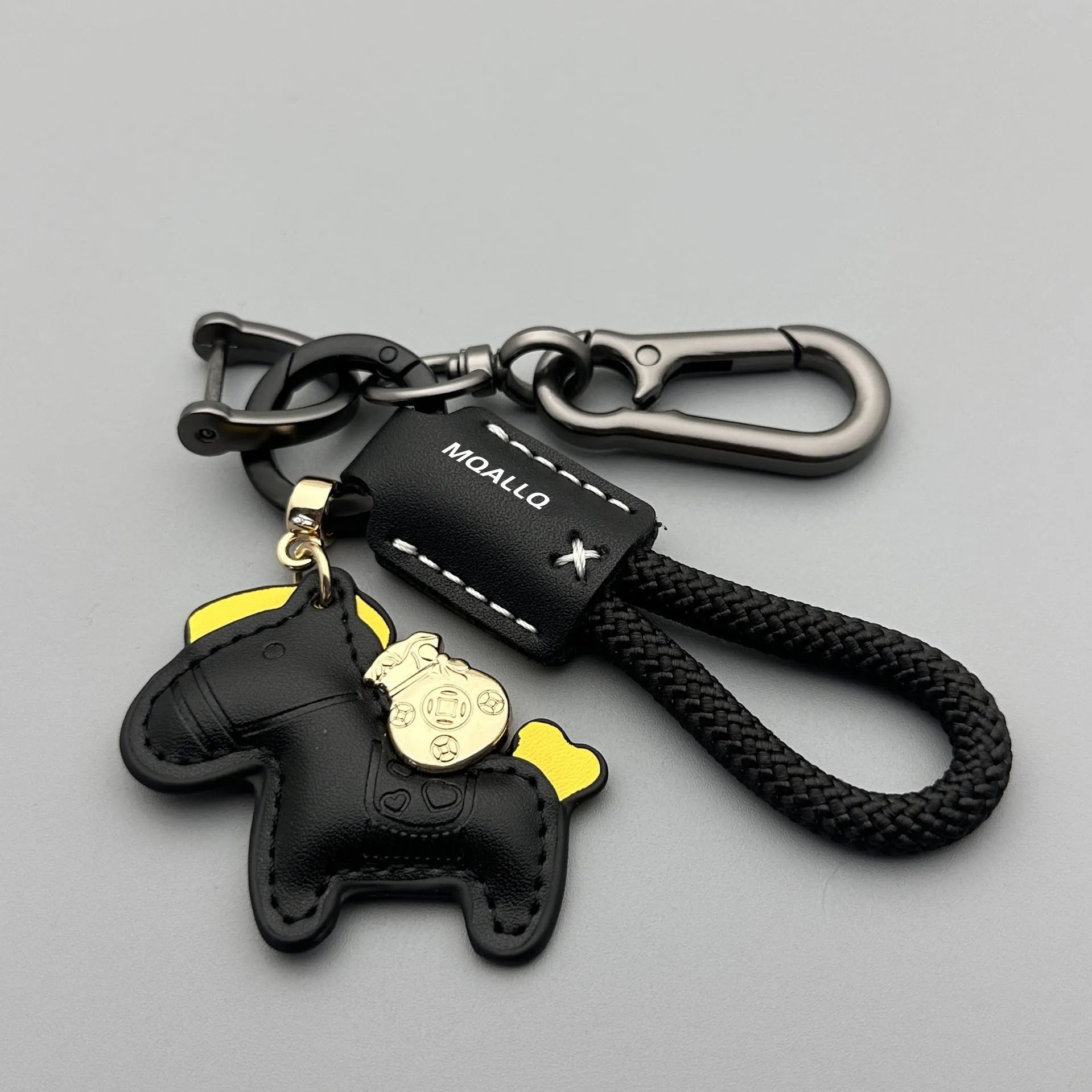 Handmade brown cowhide key ring pendant with a zinc alloy pony belt buckle and green flanelle rope.