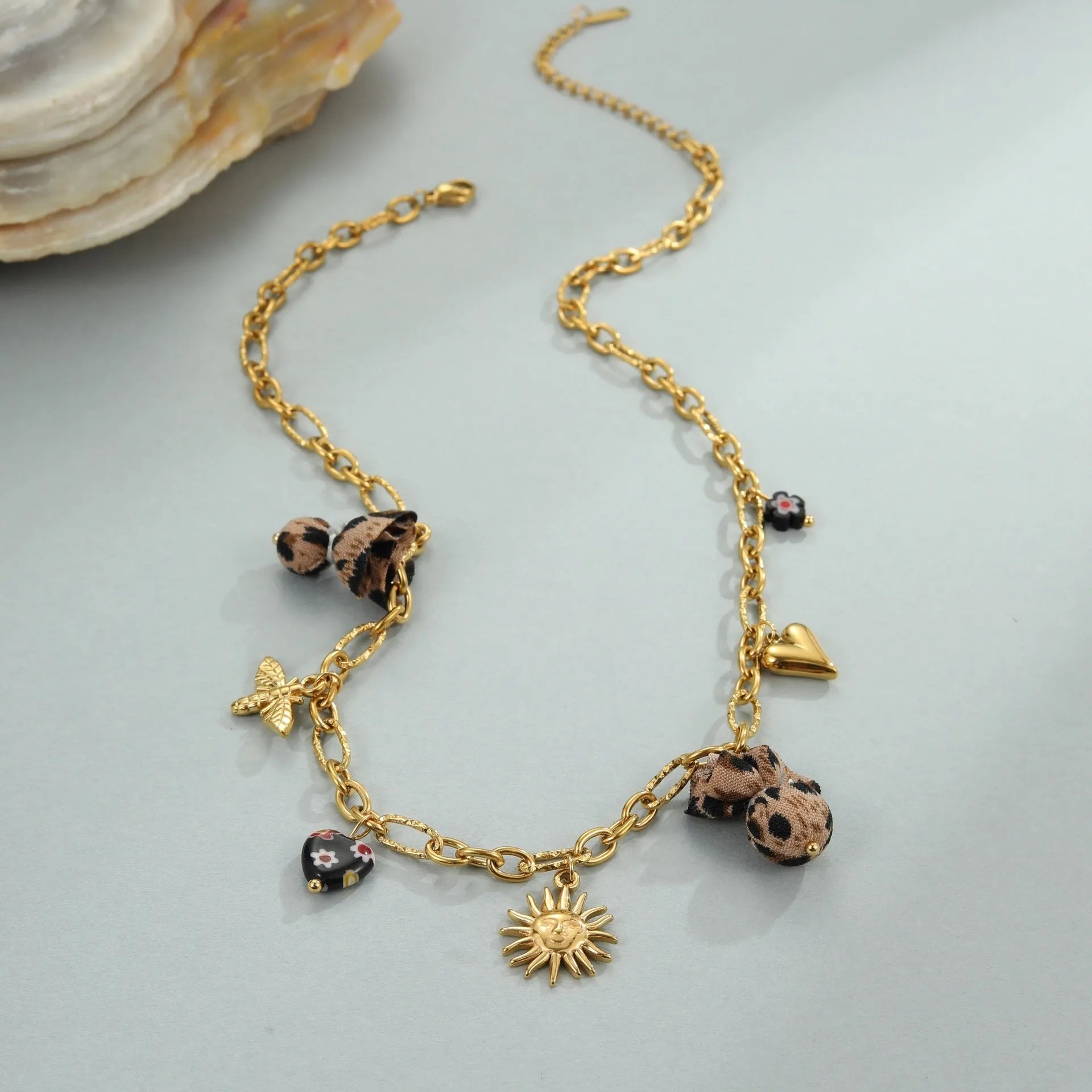 Leopard and love heart flowers pendant necklace on a stainless steel chain with gold electroplating.