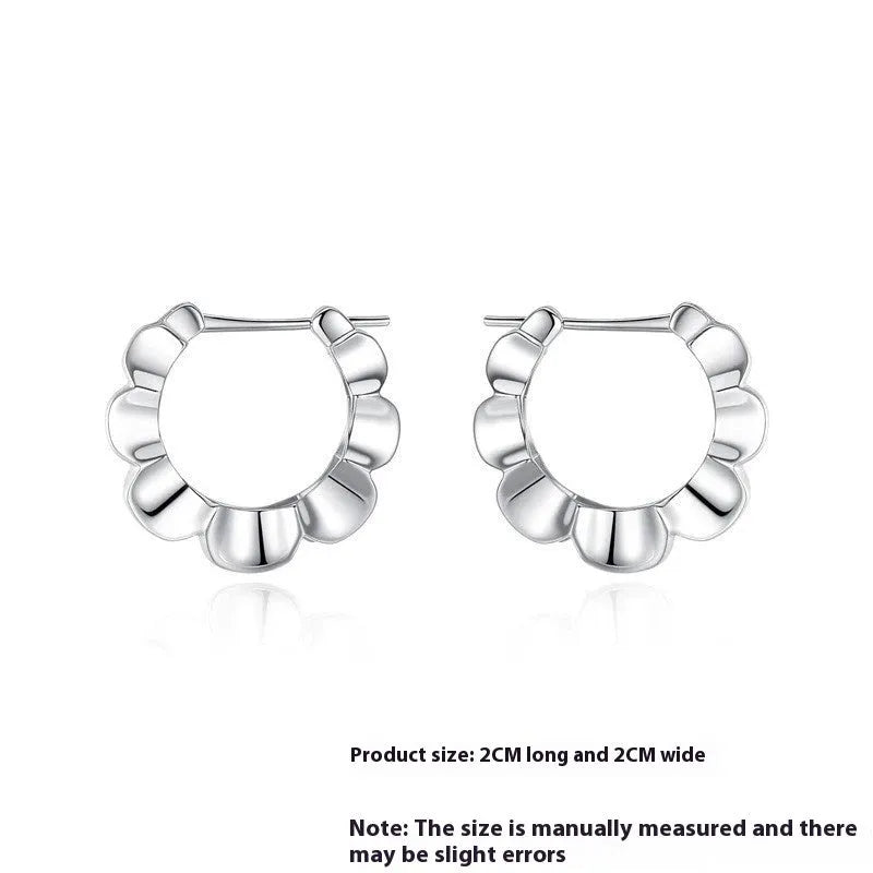 Pair of sterling silver geometric earrings with round design elements and electroplated finish