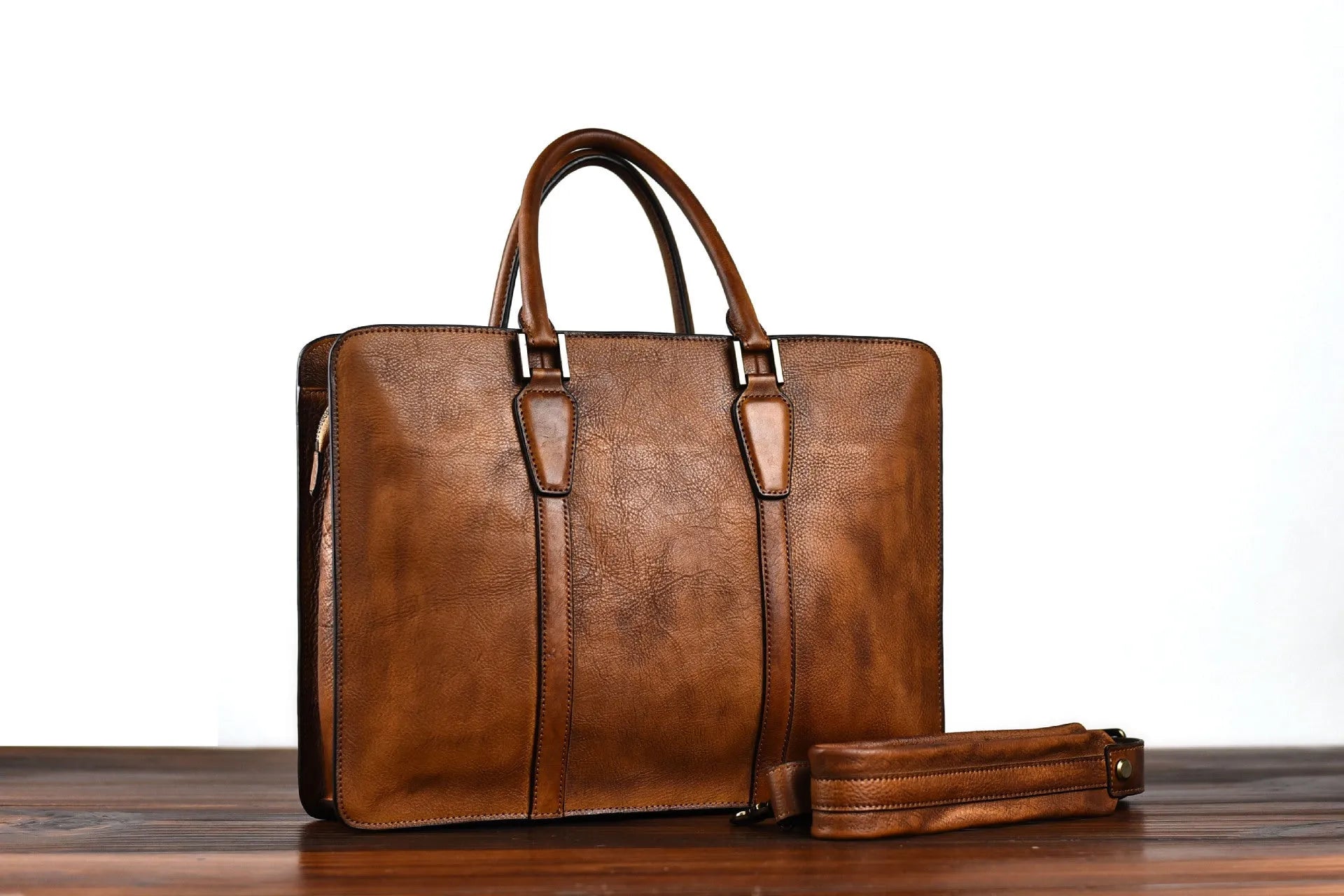 Men's brown leather handbag with horizontal design and zipper opening