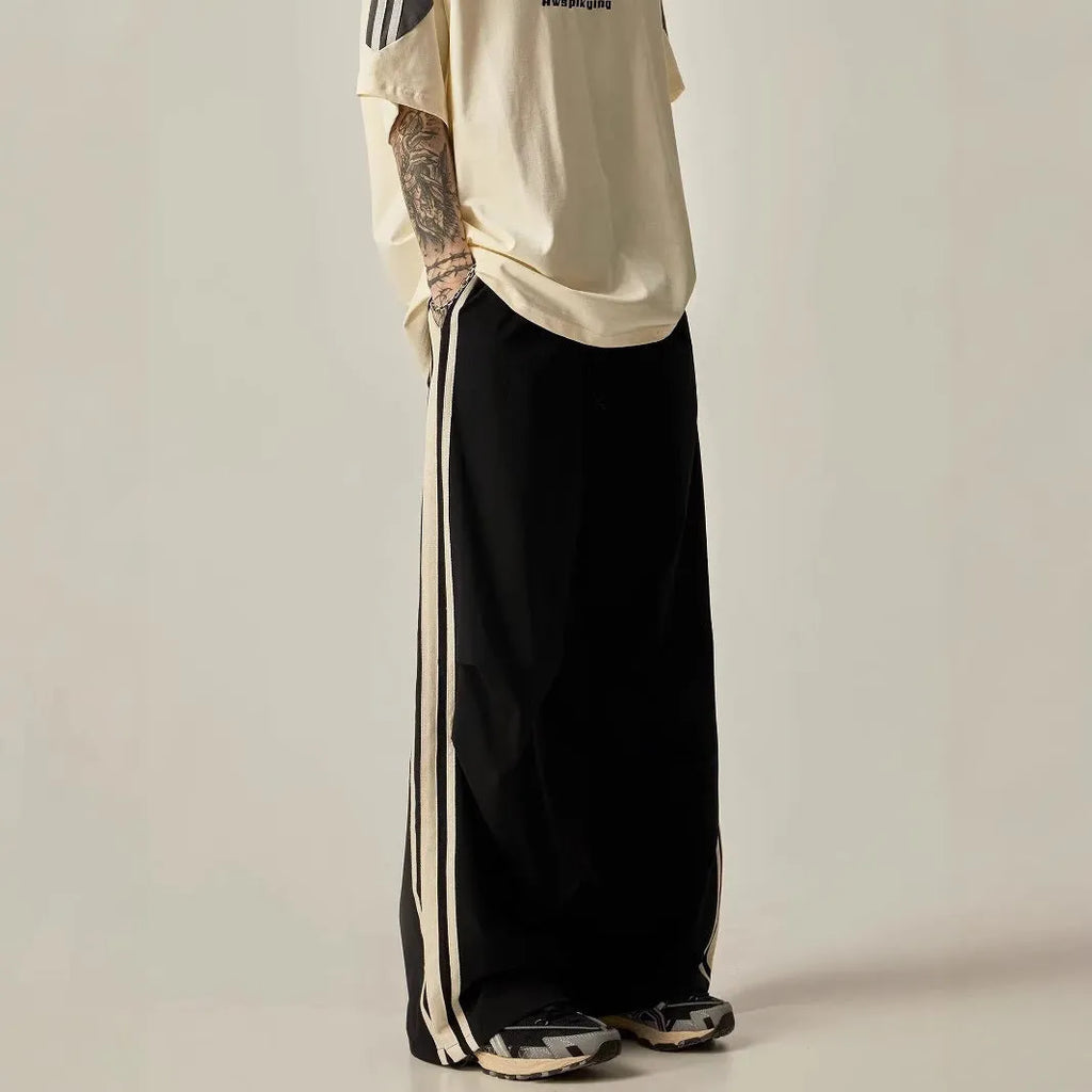 Black men's high waist wide leg climbing trousers on a hanger.