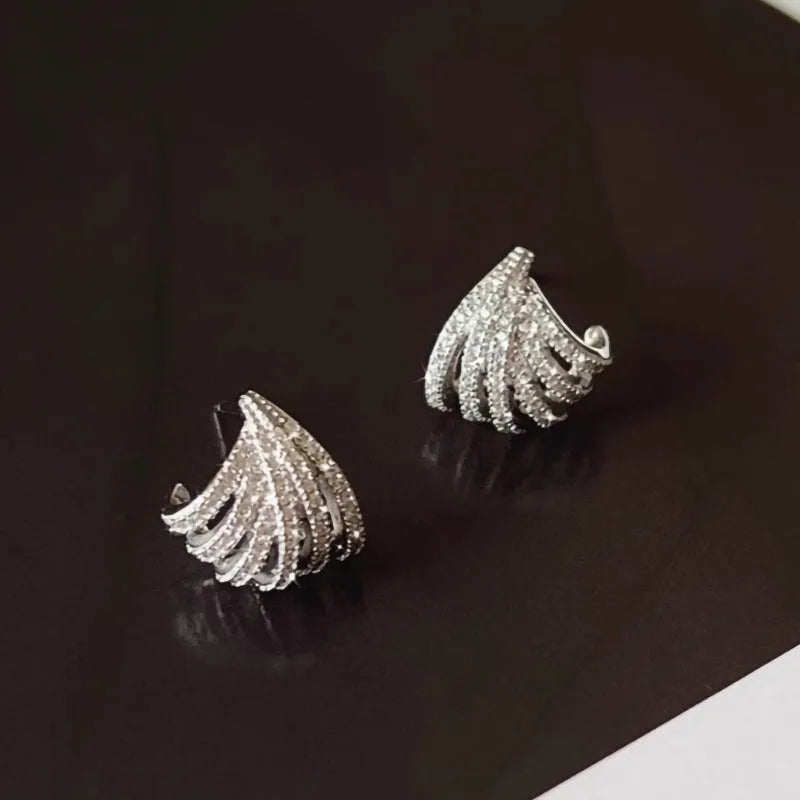 A pair of geometric-shaped earrings with a line design, made from zircon with an electroplated platinum finish.