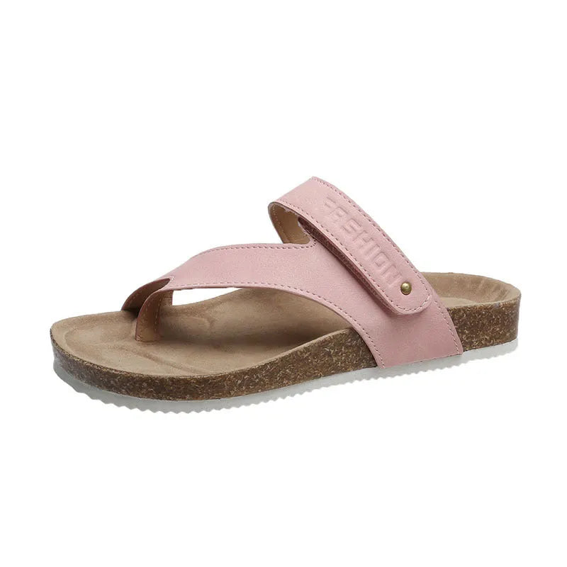 A pair of thick-soled flat toe ring flip flops in a solid colour, showing the foam sole and artificial PU upper.