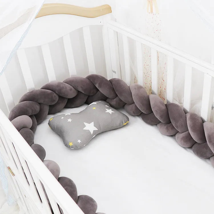 Braided knot style baby cot bumper in spandex crystal velvet fabric, shown in a light grey colour.