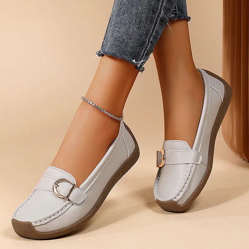 Women's beige casual loafers with round toe and flat beef tendon sole on a white background.