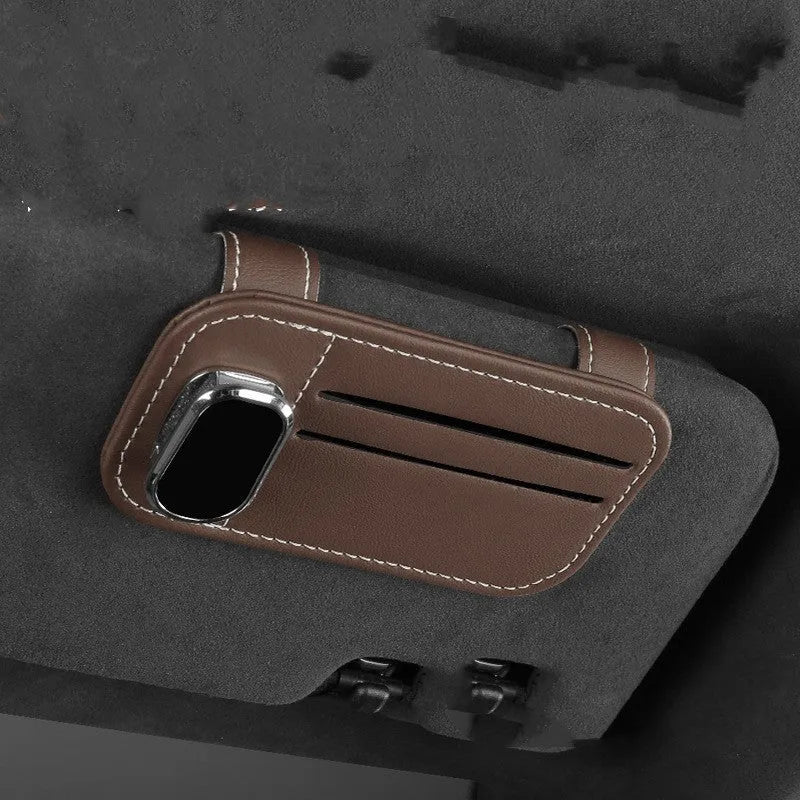 Cowhide car sun visor holder with card slots and a sunglasses clip attached to a grey visor.