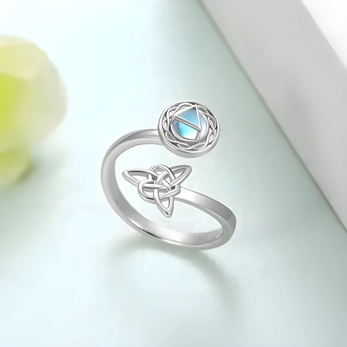 Rotating moonstone ring bracelet in white gold colour with adjustable opening and geometric circle triangle design