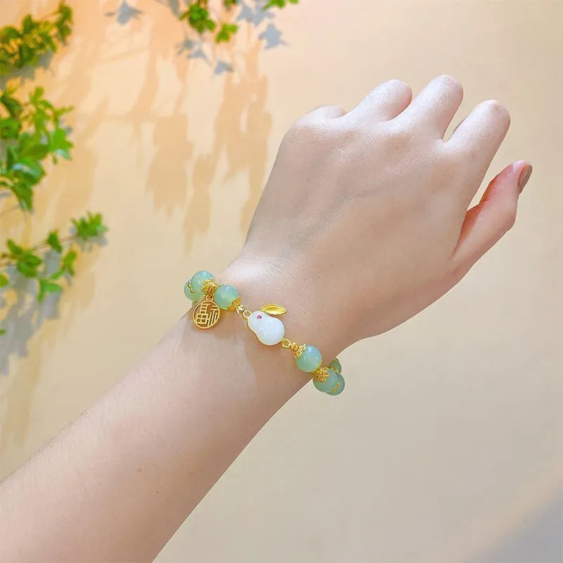 Chinese style glass bead bracelet with bamboo leaf design and manual craftsmanship details.