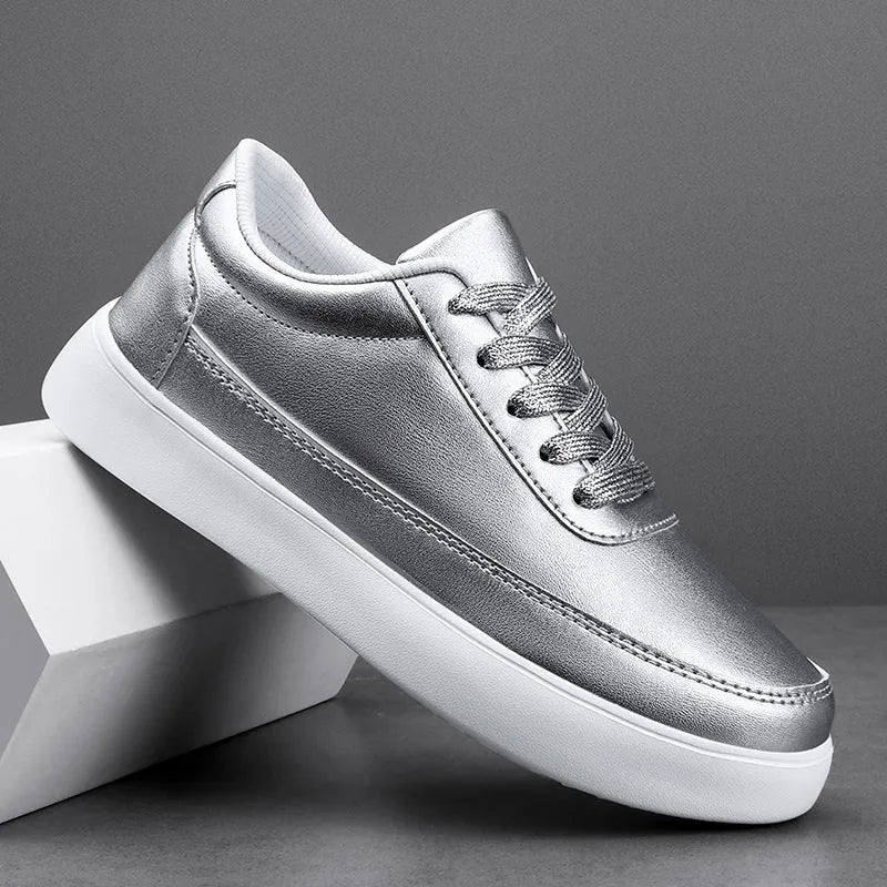 Women's gold leather flat casual lace-up shoes on a white background.