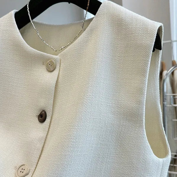 Women's milky white sleeveless bandage vest with round neck, laid flat on a surface.