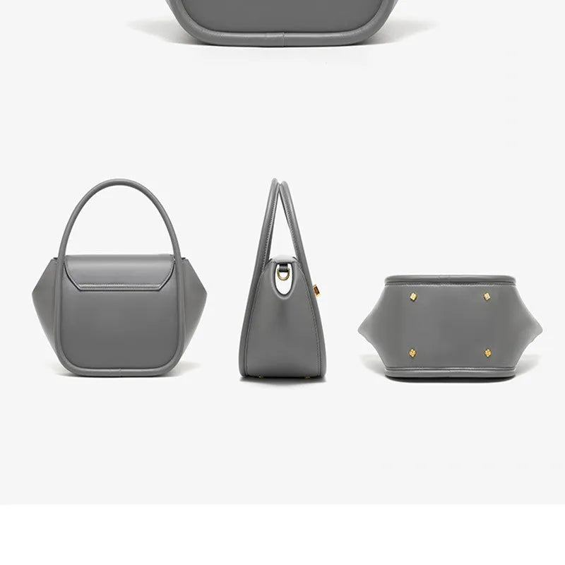 A women's cow leather wing-shaped handbag with a latch closure and a single shoulder strap.