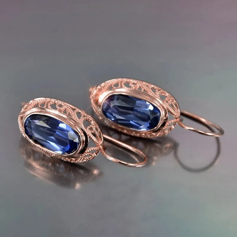 Women's copper and glass geometric earrings in red and blue with ellipse and ring shapes