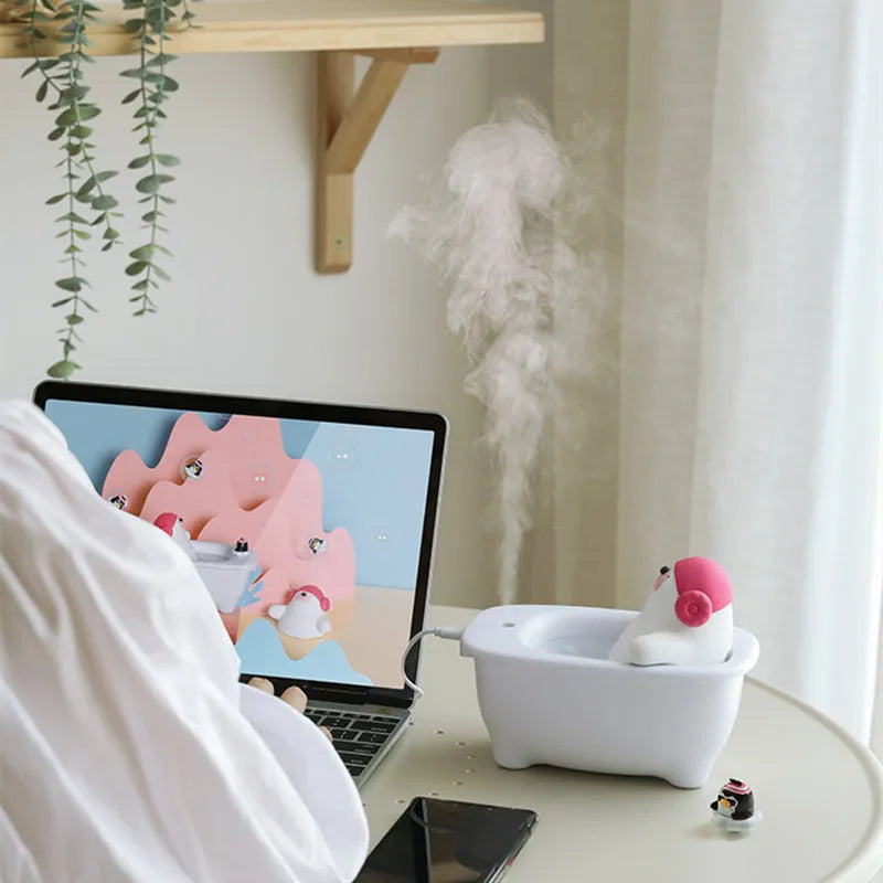 White Creative USB desktop air humidifier and scent diffuser on a wooden table.