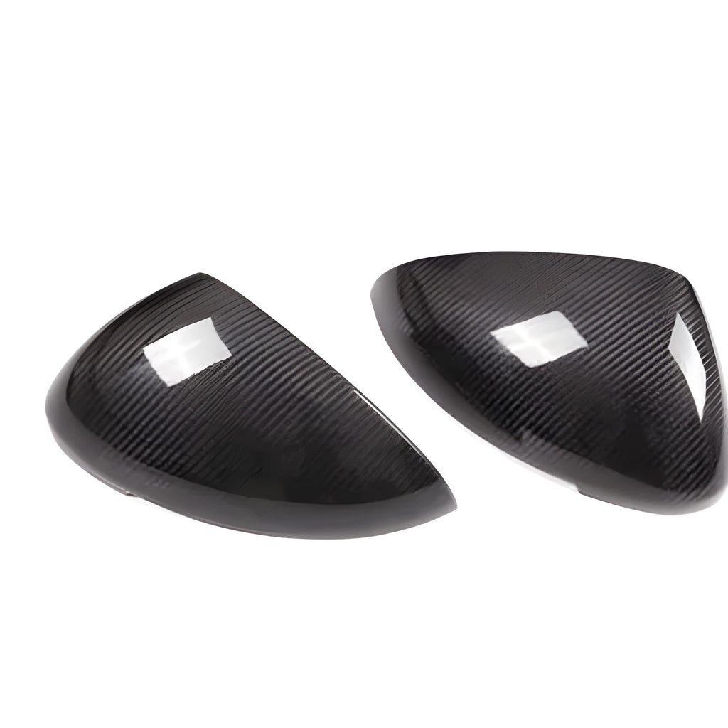 Pair of black true carbon fibre rearview mirror covers for Porsche Macan, showing textured weave pattern.