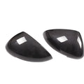 Pair of black true carbon fibre rearview mirror covers for Porsche Macan, showing textured weave pattern.