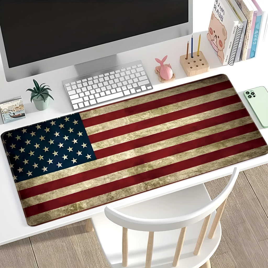 Large patterned desk mat for mouse and keyboard on a wooden desk.
