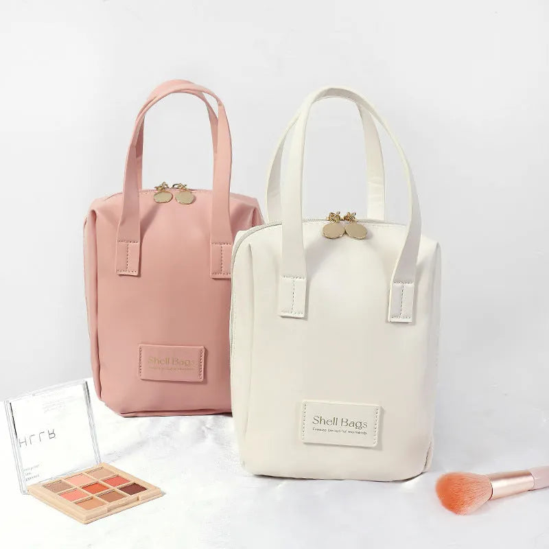 Girly heart egg shell waterproof makeup bag in solid pink with sewing line detail, 15x8x18cm, open to show PU lining