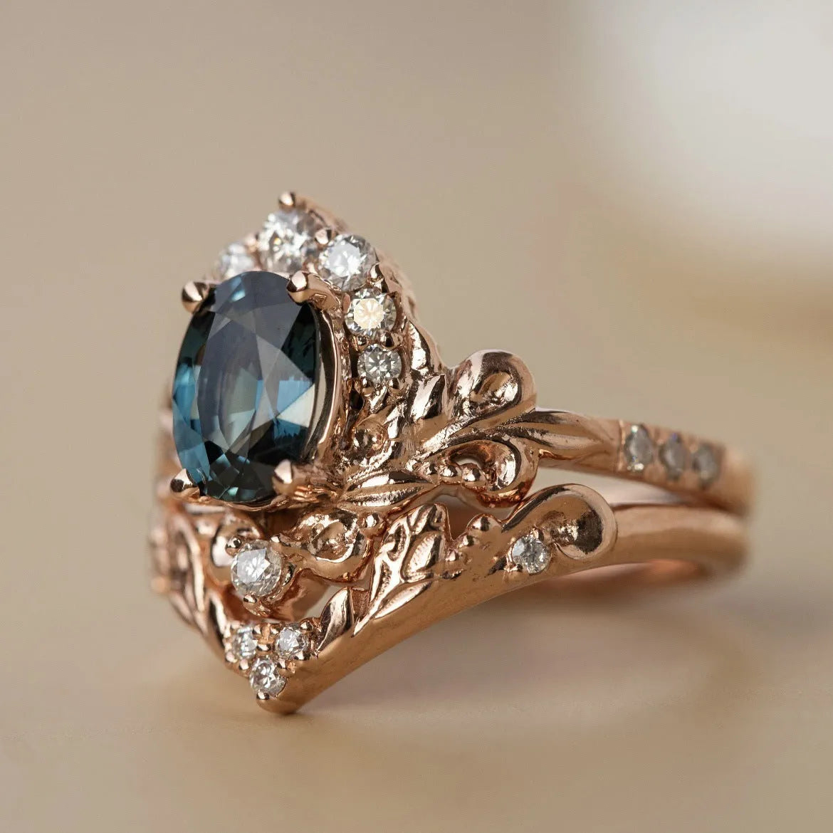 Women's rose gold branch flower ring with inlaid blue crystal, alloy construction, side view on finger