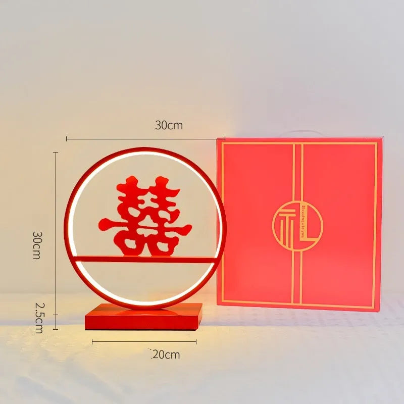 Creative red wedding lantern USB table lamp with warm light and red heart ring design on a tabletop