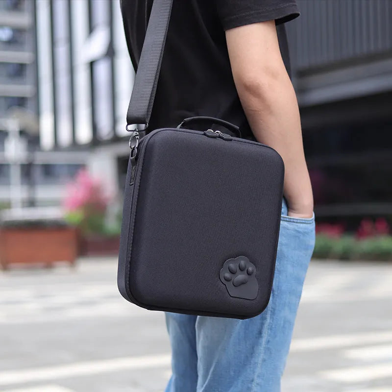 Switch console storage bag in black with shoulder strap, holding game cartridges.