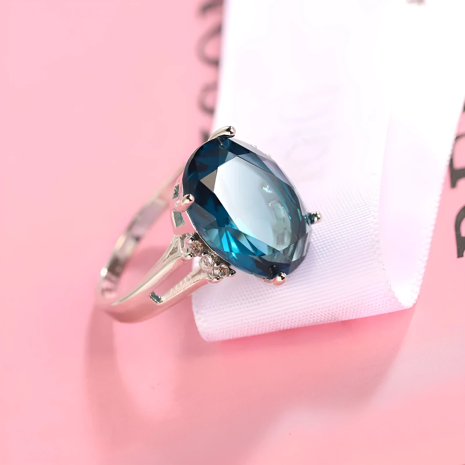 Geometric blue black zircon ring in retro copper style on a grey background.