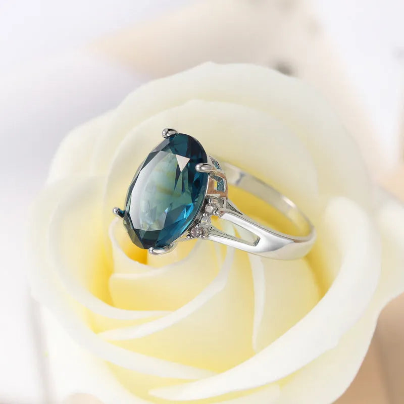 Geometric blue black zircon ring in retro copper style on a grey background.