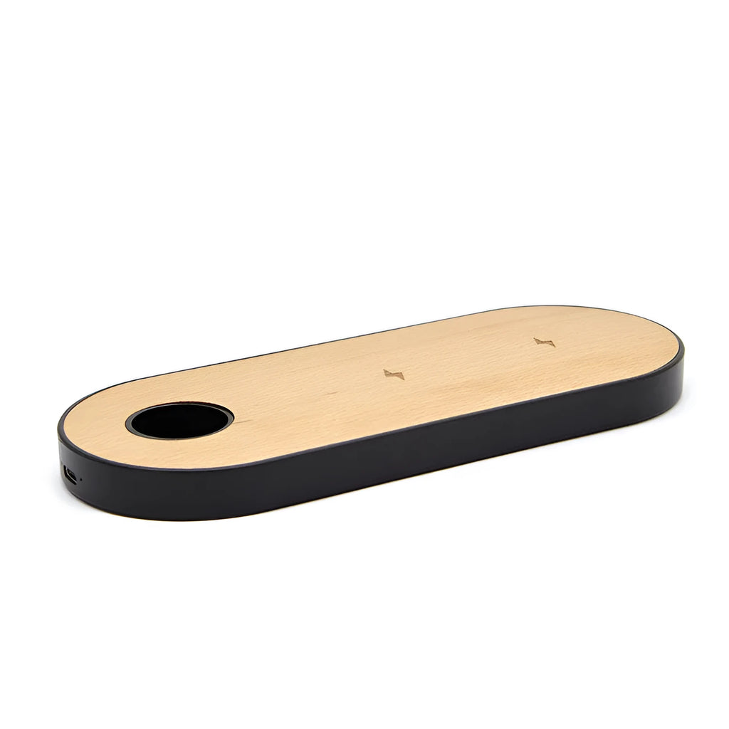 Bamboo wireless charging pad with beech wood trim on a desk