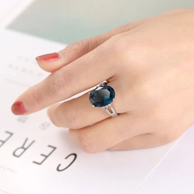 Geometric blue black zircon ring in retro copper style on a grey background.