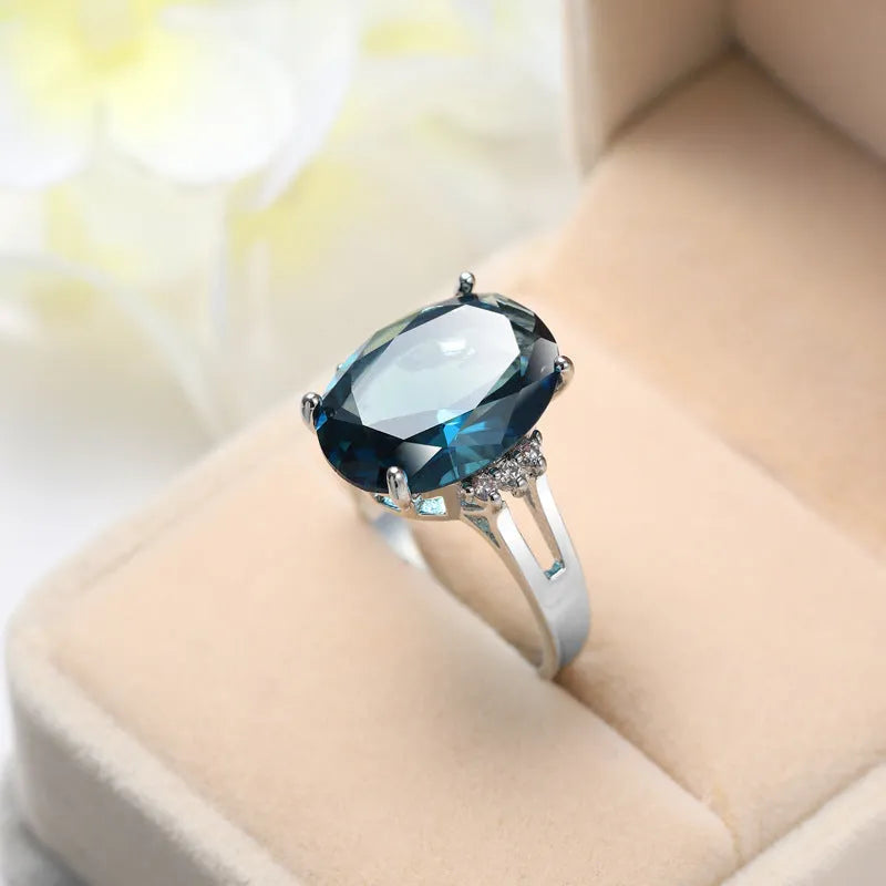 Geometric blue black zircon ring in retro copper style on a grey background.