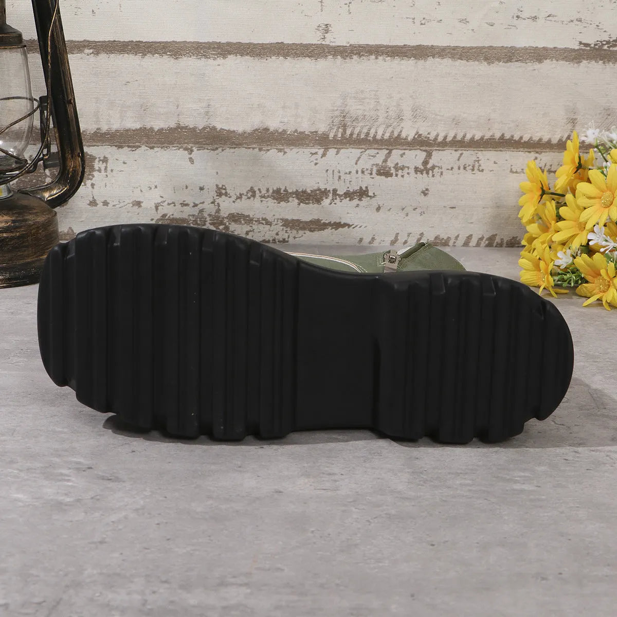 Women's black platform Martin boots with side zip and chunky rubber sole.