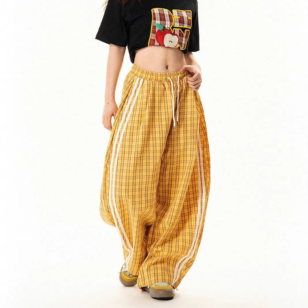 Blue loose straight wide leg polyester trousers with pockets and mid-waist design on a model