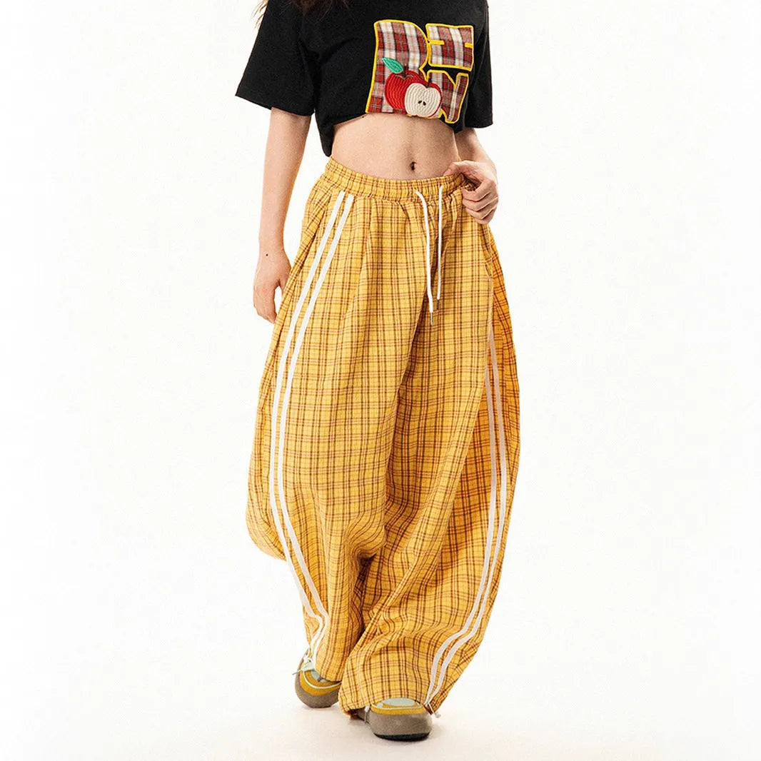 Blue loose straight wide leg polyester trousers with pockets and mid-waist design on a model