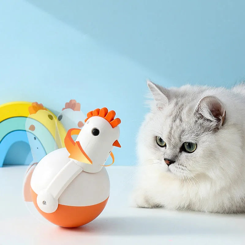 Green electric cat toy chicken with laser light feature on flat surface