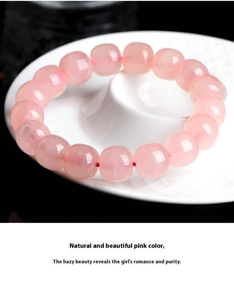 Pink natural crystal bracelet with barrel-shaped 8x10mm beads in a geometric design.