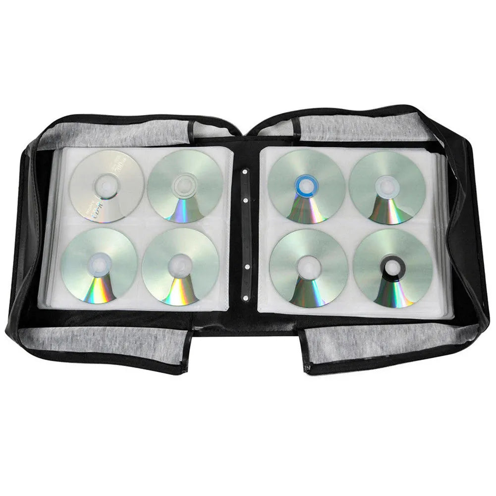 Black Oxford fabric CD DVD storage binder with zipper and top hand strap open to show disc sleeves.