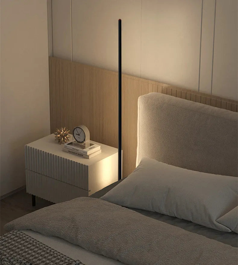Vertical aluminium floor lamp in modern simple style shown at different heights on a table.