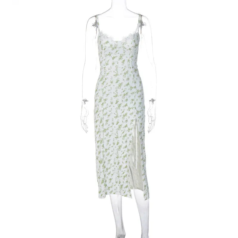 Women's blue lace flower print long dress with thigh slit and black suspender straps.