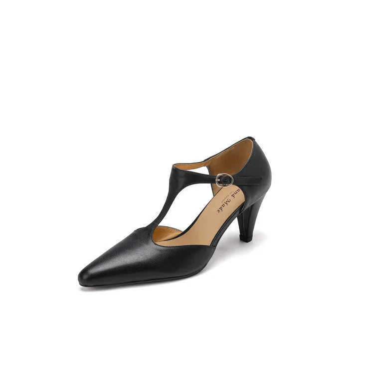 Brown retro women's sandals with T-strap, closed round toe, and a stout heel on a wooden background.