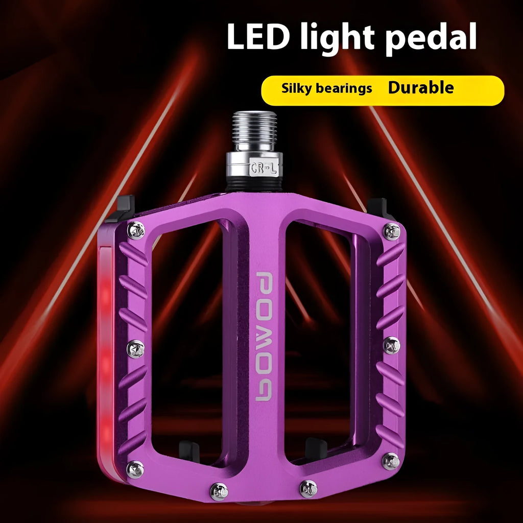 Aluminium alloy bicycle pedals with built-in LED lights in purple, black, titanium, red, and gold colour options.