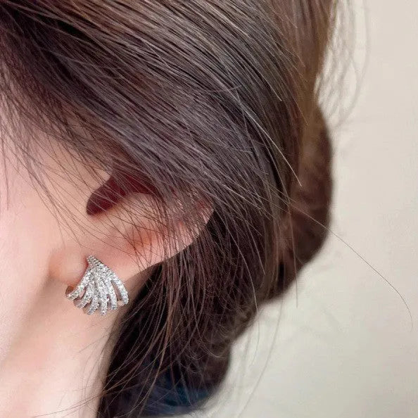 A pair of geometric-shaped earrings with a line design, made from zircon with an electroplated platinum finish.