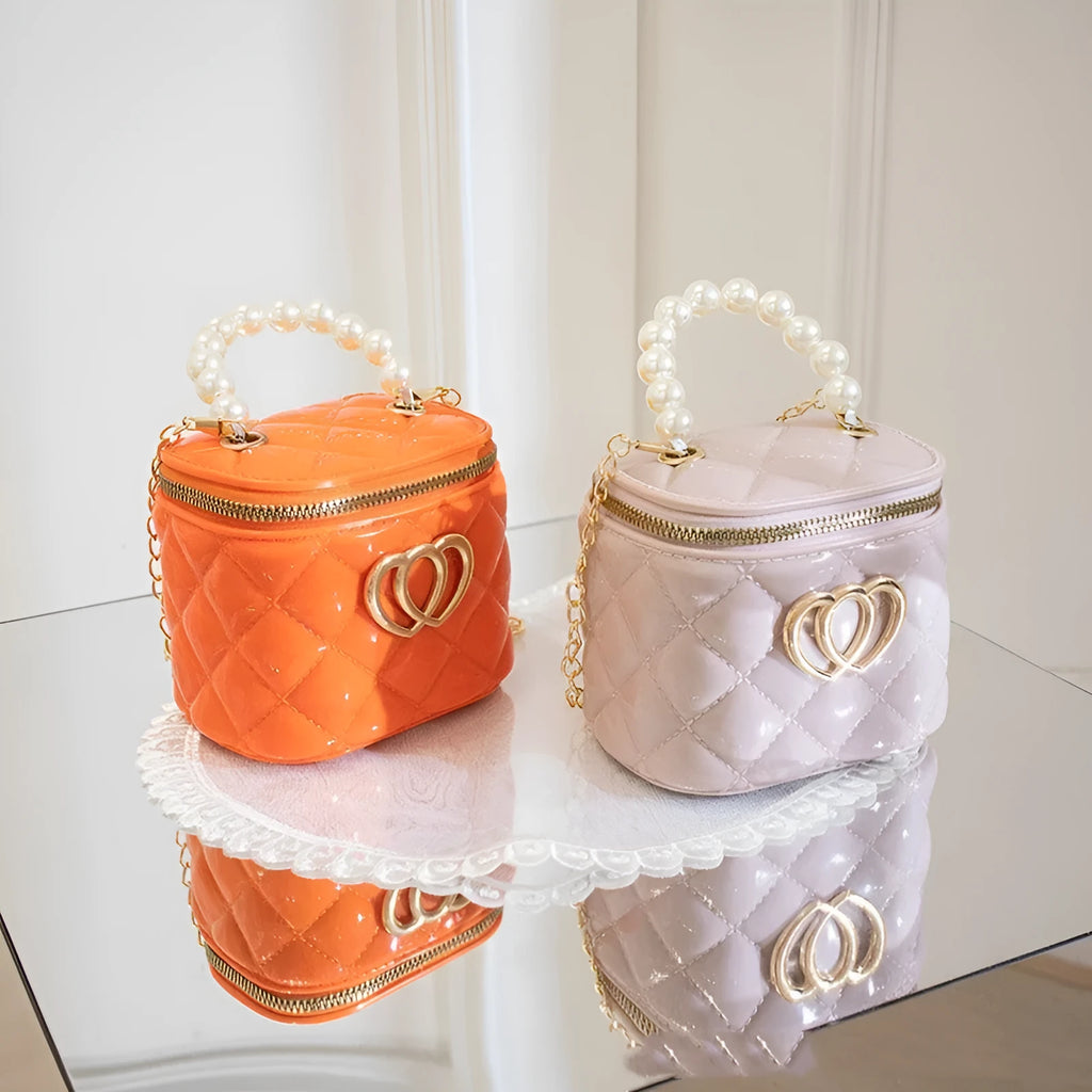 White PVC bucket-shaped cosmetic bag with a heart pattern, shown open.