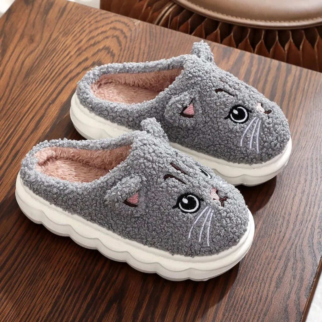 Winter cartoon cat fluffy slippers with plush upper and non-slip EVA sole, in black, white, pink, or grey.