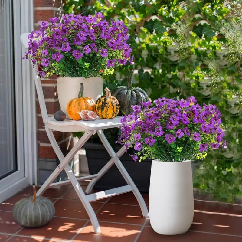 Single artificial eucalyptus flower stem in purple plastic with green leaves