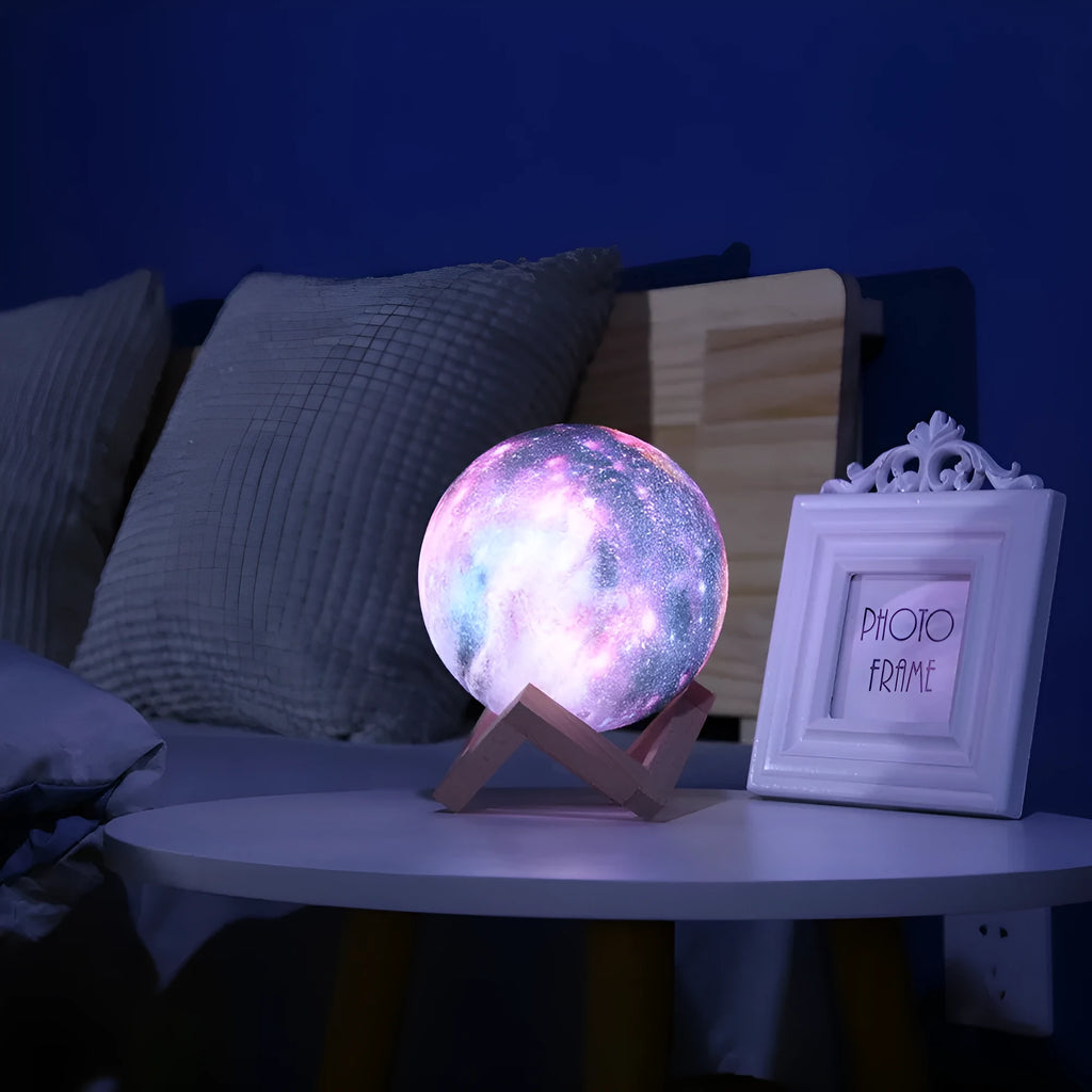 3D-printed white lunar sphere LED night light on a dark surface, showing detailed crater texture.