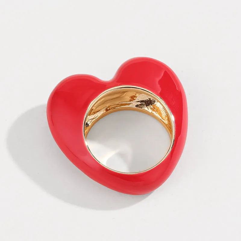 Three-dimensional enamel heart ring in multiple colours on a zinc alloy band.