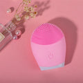 Electric ultrasonic silicone facial cleanser in pink, compact 8.2cm x 7cm x 3.5cm, with USB cable and manual